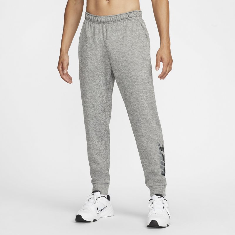 Męskie zwężane spodnie do fitnessu z nadrukiem Nike Therma-FIT Swoosh - Szary